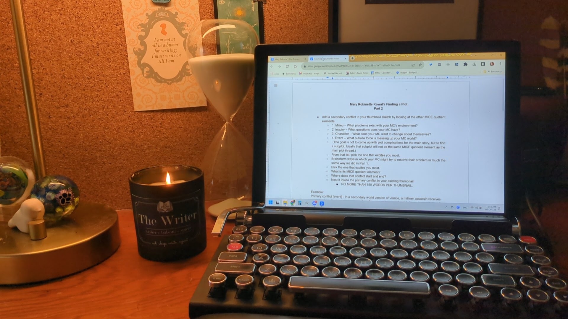 Mary Robinette's desk on which we see her computer screen that has a sample of one of the worksheets from class. It is titled "Mary Robinette Kowal's Finding a Plot Part 2"